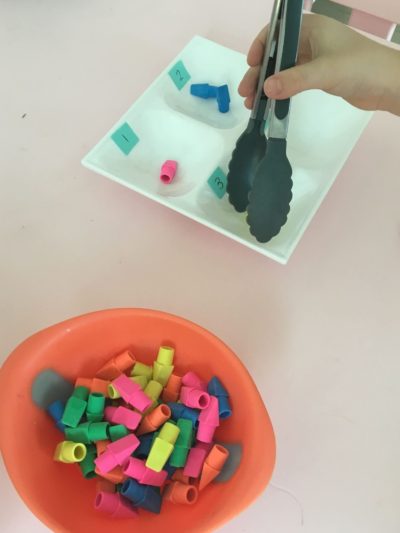 sorting objects with tongs
